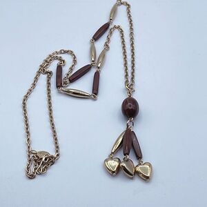 Vintage Sarah Coventry long Boho necklace with heart tassel type decor.